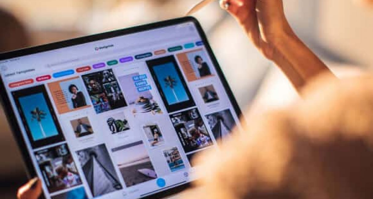 Person using a tablet to design and manage digital marketing content.